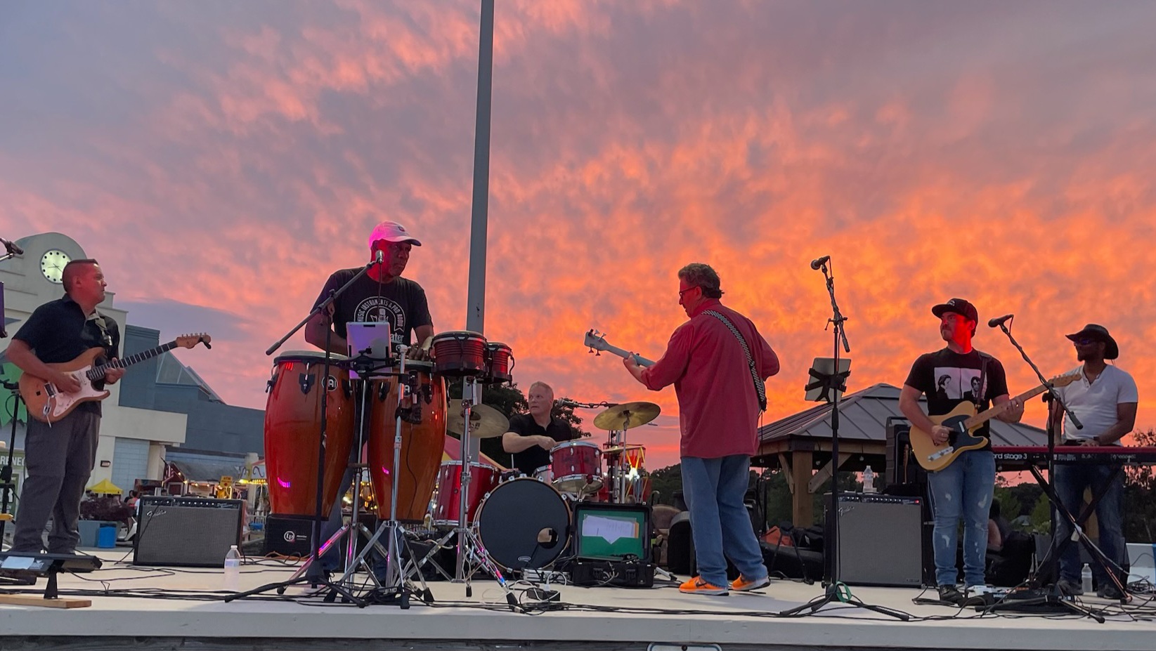 Andre's band performing on stage at sunset at Ocean Beach Park